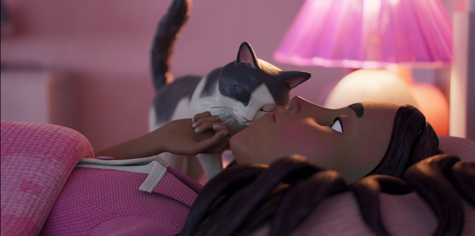 A girl is lying on her back with her eyes open, smiling gently as a gray and white cat nuzzles her cheek. The room is softly illuminated by a pink lamp, creating a warm, cozy atmosphere. The girl is dressed in a pink garment, and her dark hair cascades around her face.