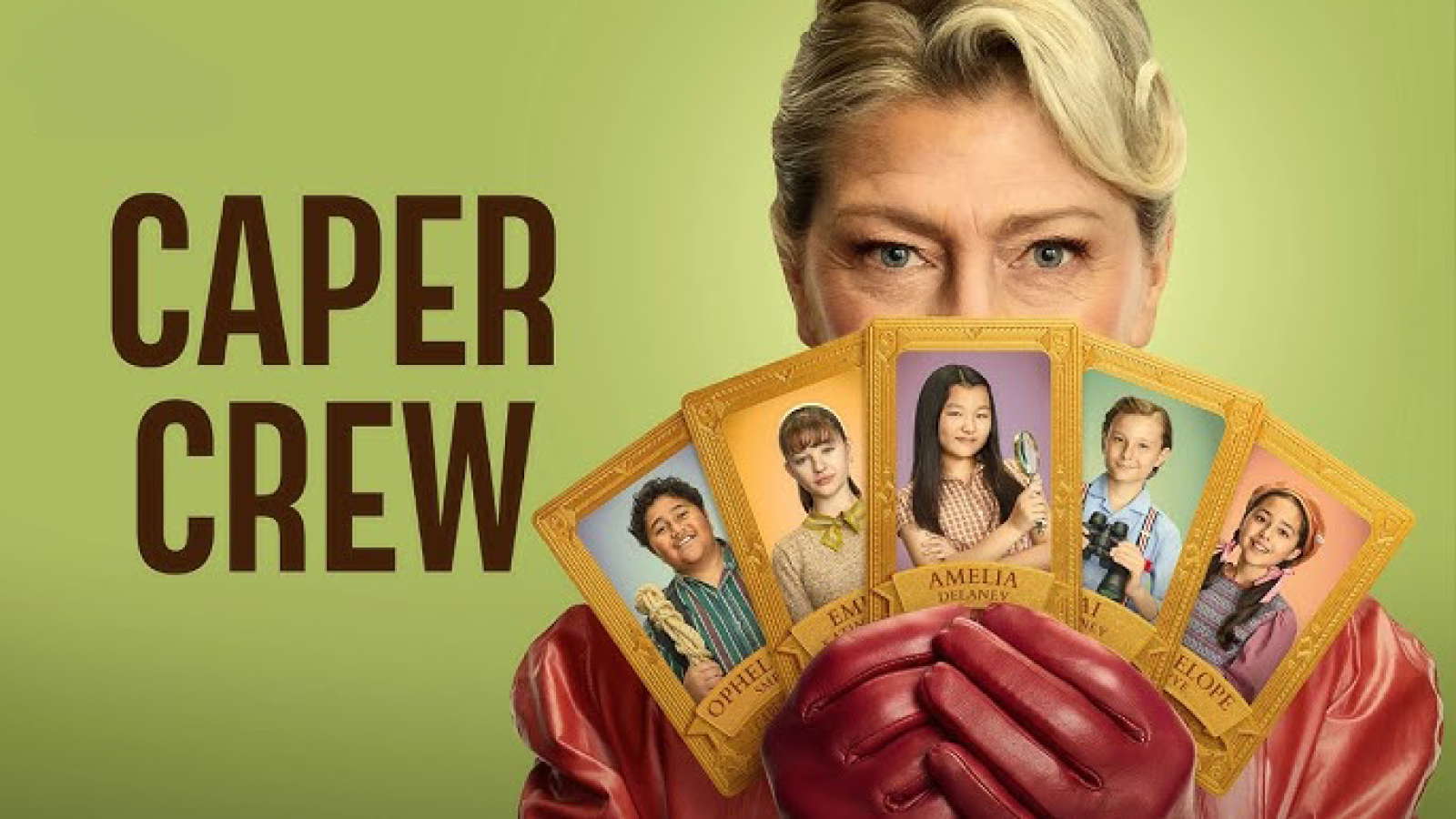 A woman with styled blonde hair holds several colorful character cards in front of her, showcasing five diverse children. The background features a soft green hue, with the text "CAPER CREW" prominently displayed next to her.