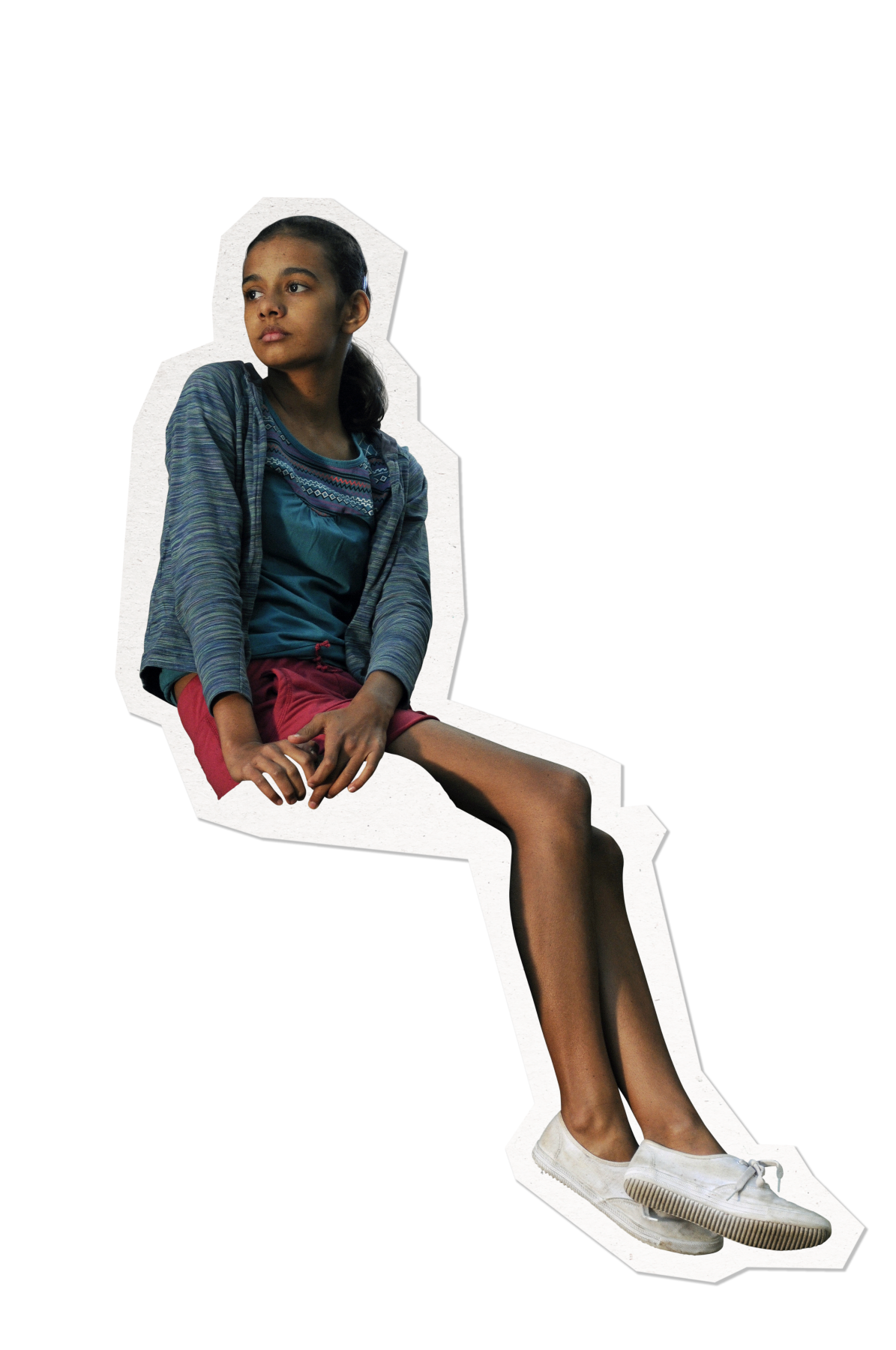 A young girl sits in a thoughtful pose, wearing a light blue cardigan over a teal top and red shorts. She has long legs and is barefoot in white shoes, with her dark hair partially tied back. The background is solid black, emphasizing her figure.