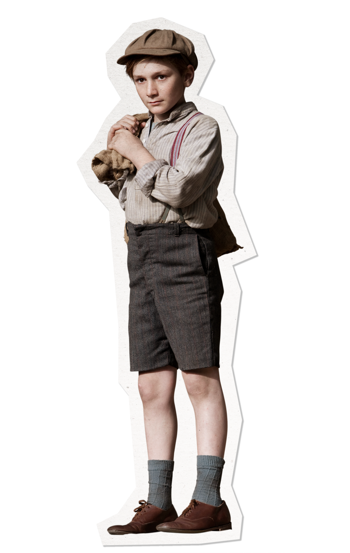 A young boy stands confidently, dressed in a striped shirt and suspenders, paired with knee-length shorts. He wears a cap and has brown shoes, along with knee-high socks. He holds a small bag close to his chest, exuding a vintage charm.