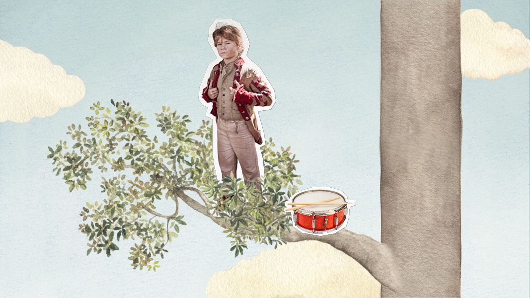 A young boy stands confidently on a tree branch, wearing a red jacket and trousers, with his hands on his hips. Nearby, a bright red drum rests on the branch, while soft clouds float in a light blue sky.